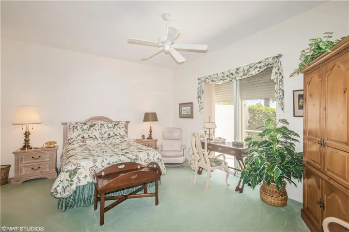 Carpeted bedroom with ceiling fan