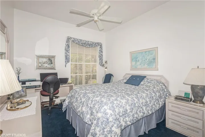 Carpeted bedroom with ceiling fan