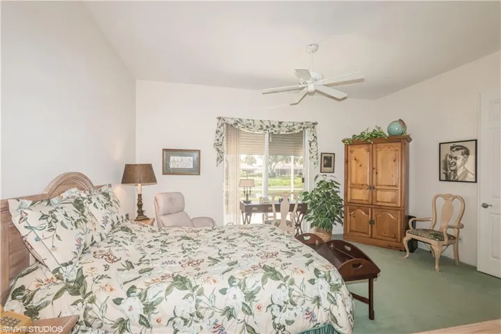 Bedroom with light carpet and ceiling fan