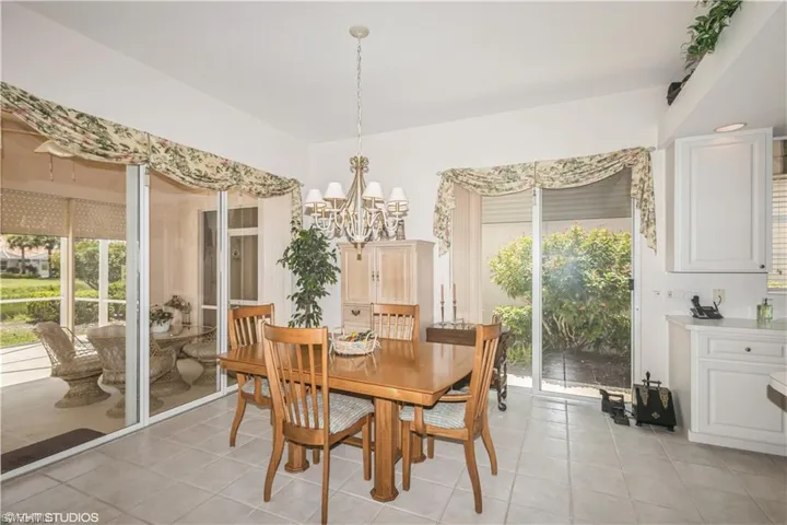 Tiled dining area with an inviting chandelier