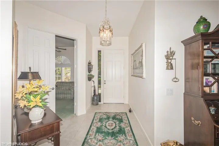Foyer featuring a notable chandelier and light tile floors