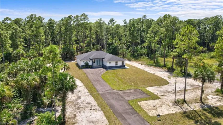 View of subject property with a forest