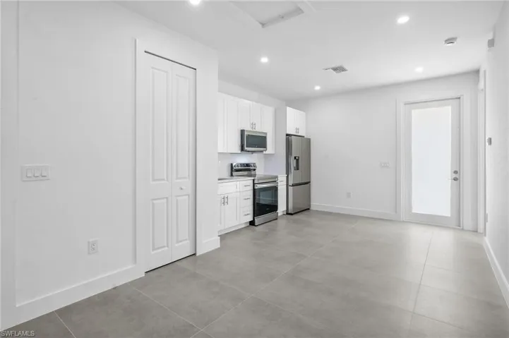Mother In Law Kitchen featuring white cabinets, appliances with stainless steel finishes, light countertops, and recessed lighting