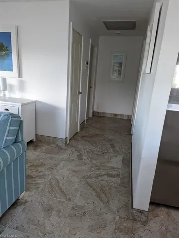Corridor featuring baseboards