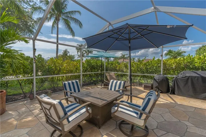 View of patio / terrace featuring grilling area and glass enclosure