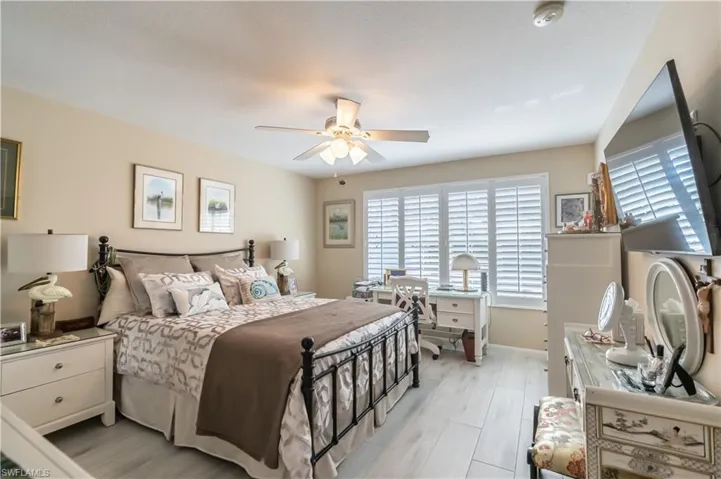 Bedroom featuring ceiling fan and light hardwood / wood-style flooring