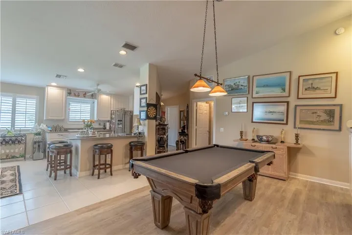 Rec room featuring ceiling fan, light wood-type flooring, vaulted ceiling, and pool table
