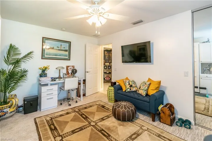 Living room with light carpet and ceiling fan