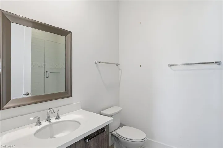 Full bathroom with vanity and a shower stall