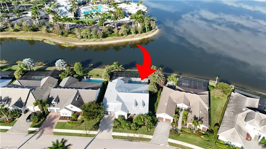 Aerial view of residential area featuring a large body of water