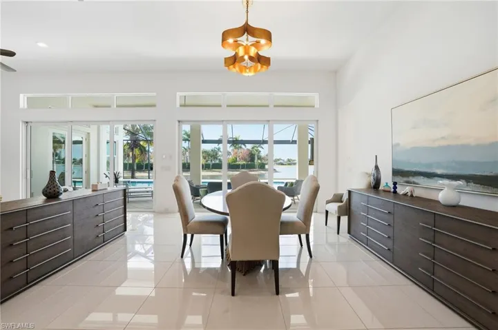 Dining area with light tile patterned floors