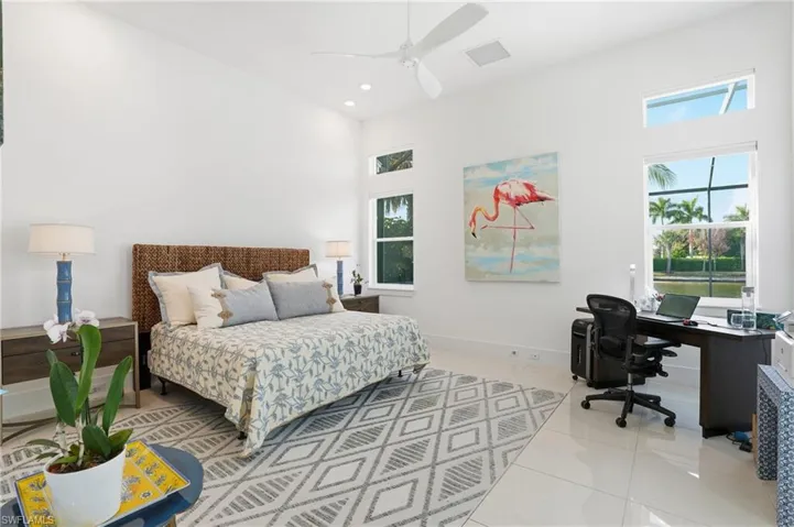 Bedroom featuring an office area, light tile patterned floors, ceiling fan, and recessed lighting