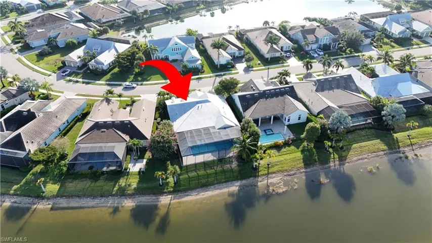 Aerial perspective of suburban area featuring a nearby body of water