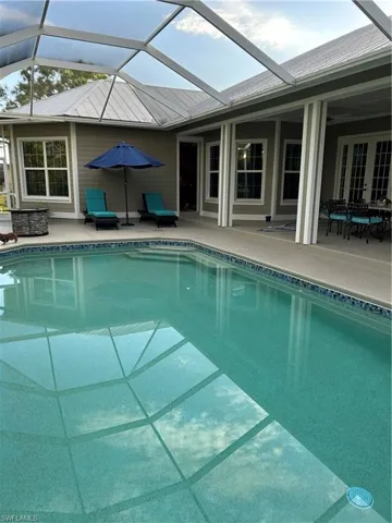 View of pool with a patio and a lanai