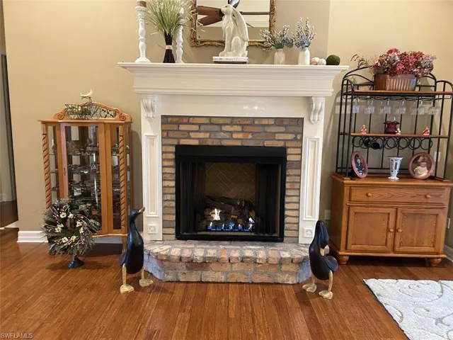 Interior details with a fireplace and wood-type flooring