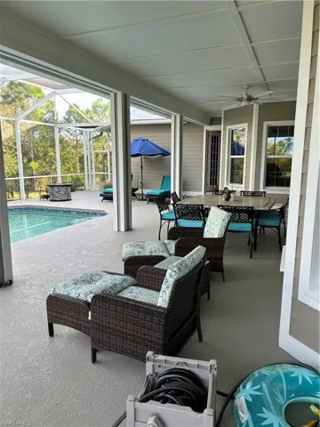 View of patio featuring a lanai