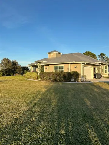 View of front of house featuring a garage and a front yard