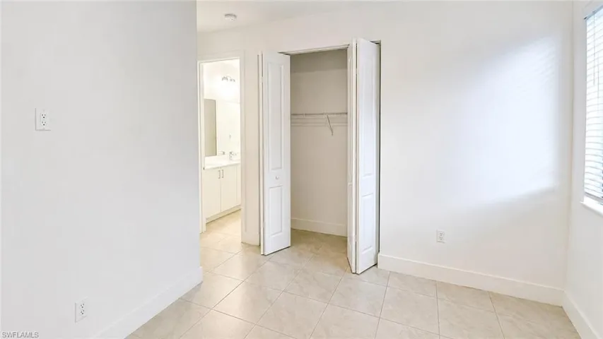 Room featuring tile flooring and white baseboards