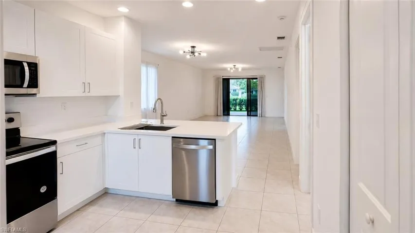 Modern kitchen with white cabinetry and light countertops