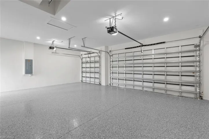 Garage with electric panel and a garage door opener