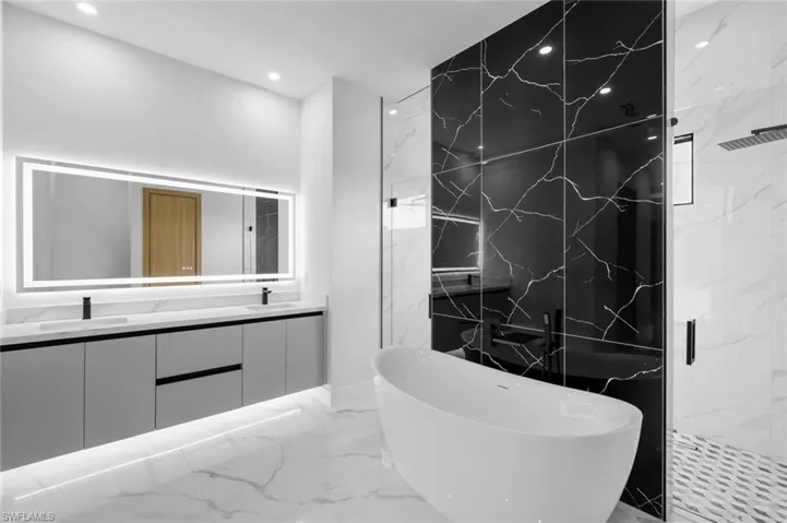 Bathroom with vanity and independent shower and bath
