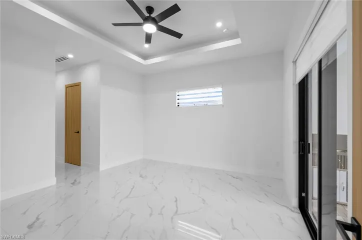 Spare room featuring ceiling fan and a raised ceiling
