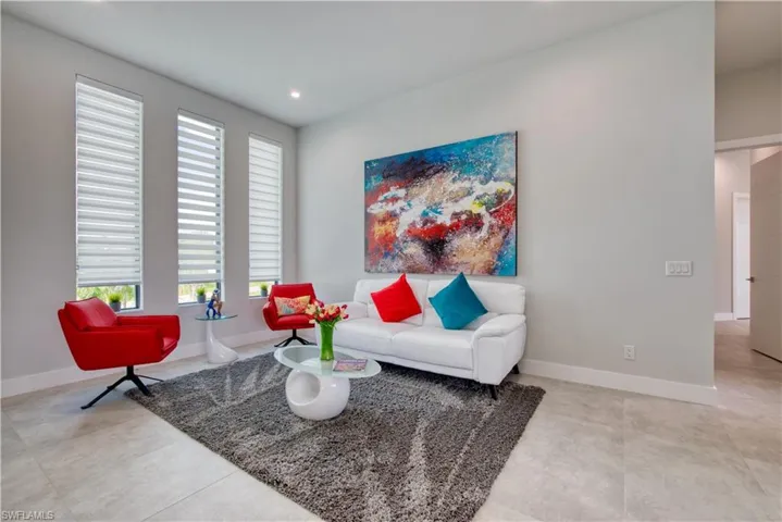 Living area featuring light gray wall paint, recessed lighting, and tile flooring