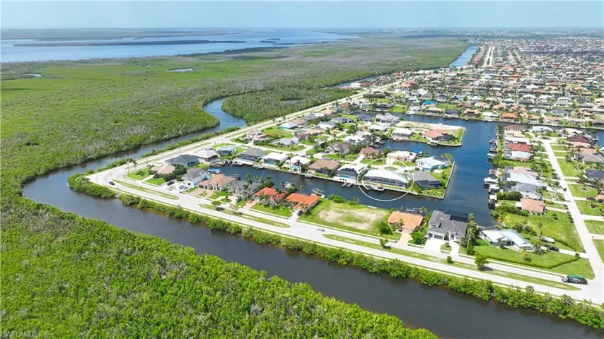 Aerial perspective showcasing a waterfront community with direct canal access