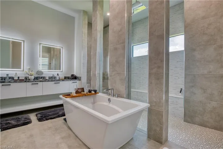 Freestanding soaking tub with floor-mounted faucet