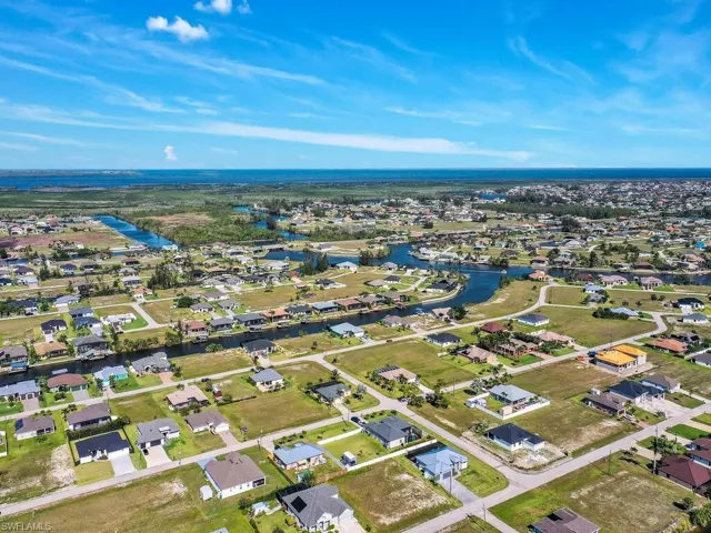 Aerial view featuring a water view and a residential view