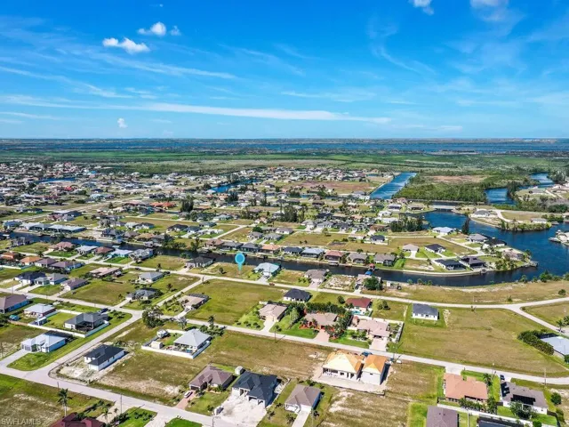 Birds eye view of property with a residential view and a water view