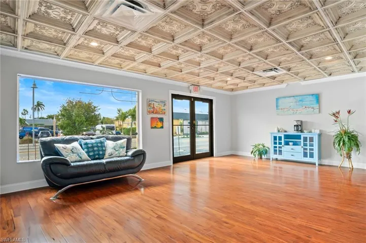 Entry way featuring french doors, coffered ceiling, and wood-type flooring
