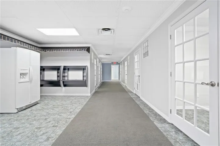 Corridor with a drop ceiling and ornamental molding