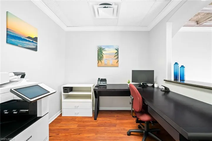 Office space with crown molding and hardwood / wood-style flooring