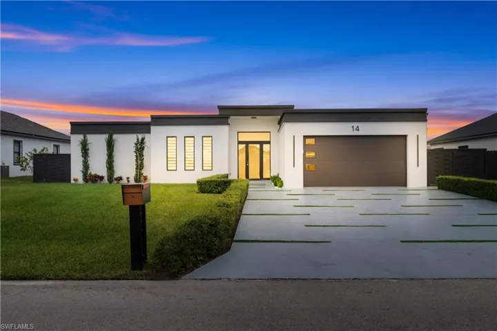 Contemporary home with a yard and a garage