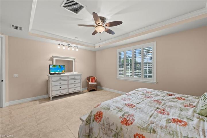 15045 Malayan Court Bonita Springs FL 34135 - Owner's bedroom with tray ceiling and view of pool
