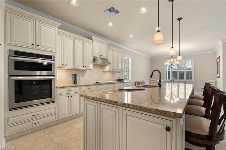 15045 Malayan Court Bonita Springs FL 34135 - Granite top island with pendant lighting above and end cabinets on both ends.