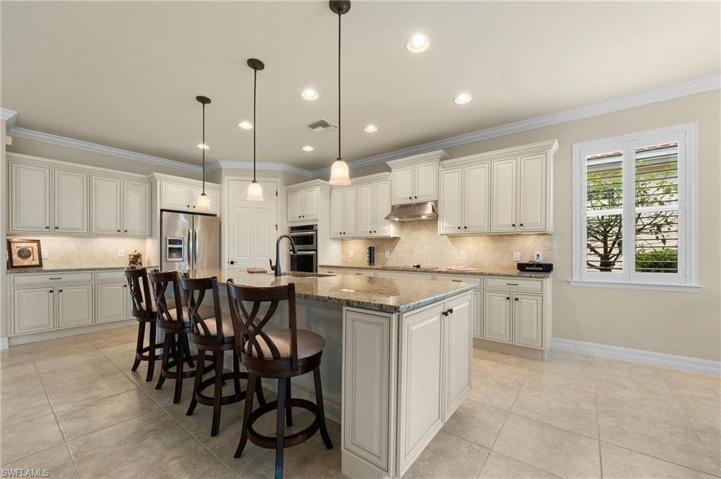 15045 Malayan Court Bonita Springs FL 34135 - Pendant lighting and recessed can lights, and under cabinet lighting provide plenty of light.