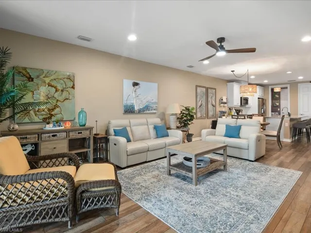 Living room featuring sink, ceiling fan, and hardwood / wood-style floors