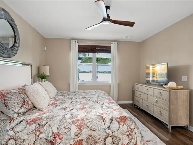 Bedroom featuring dark hardwood / wood-style flooring and ceiling fan