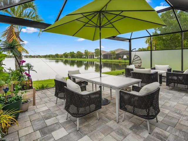 View of patio / terrace with a lanai, a water view, and an outdoor living space