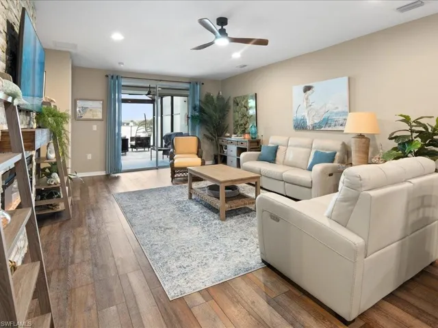 Living room featuring ceiling fan and hardwood / wood-style floors