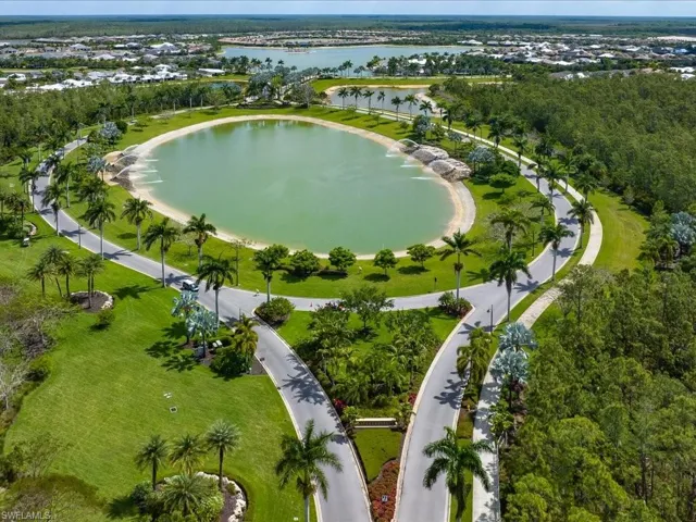 Birds eye view of property with a water view