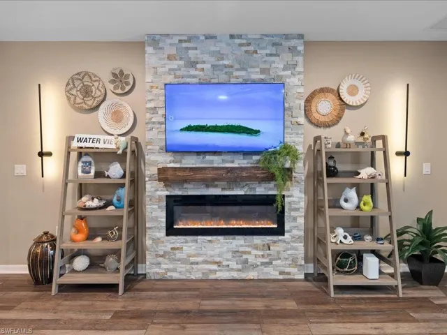 Living room featuring a stone fireplace and hardwood / wood-style floors
