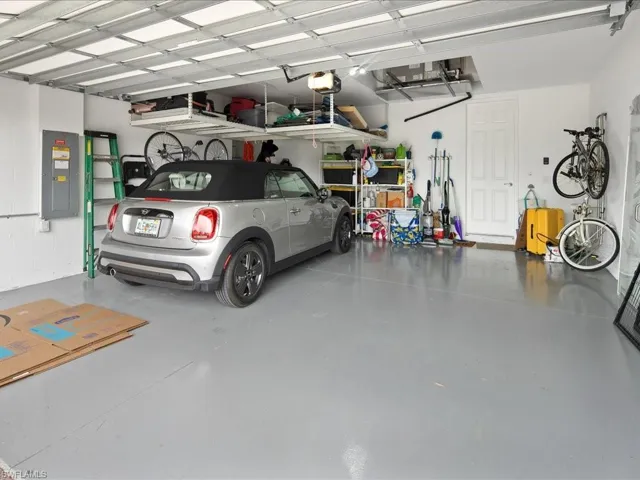 Garage with electric panel and a garage door opener