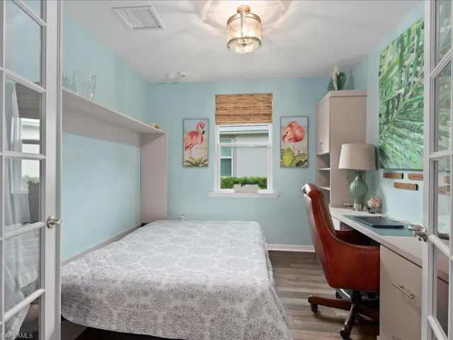Bedroom featuring wood-type flooring and french doors