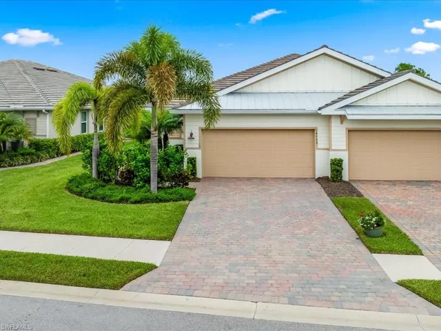 View of front of property with a garage and a front yard