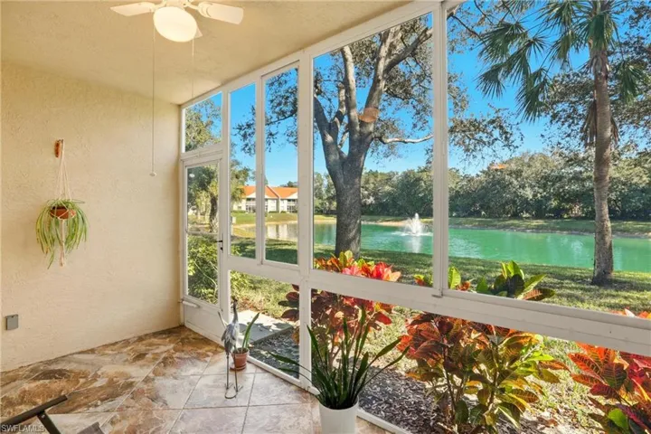 Sunroom / solarium featuring a water view