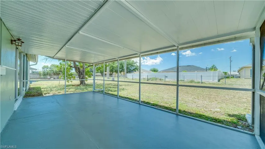 Screened in lanai with large, fenced in yard