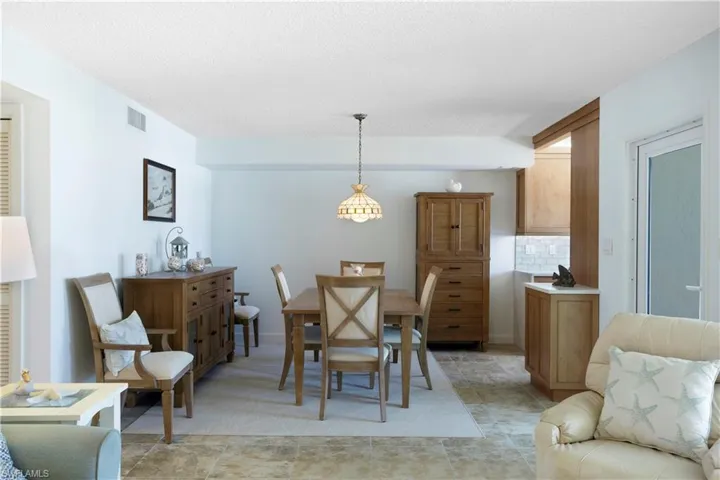 Neutral tile and wall color throughout the condo except for carpet in bedrooms.